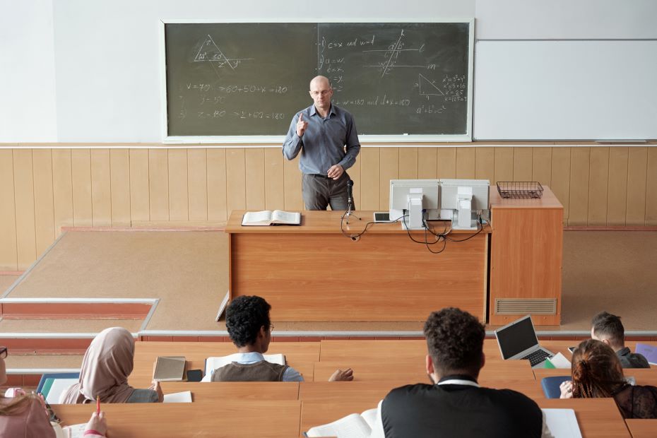 bald-mature-professor-standing-by-desk-in-front-of-2023-11-27-05-03-50-utc (2).jpg